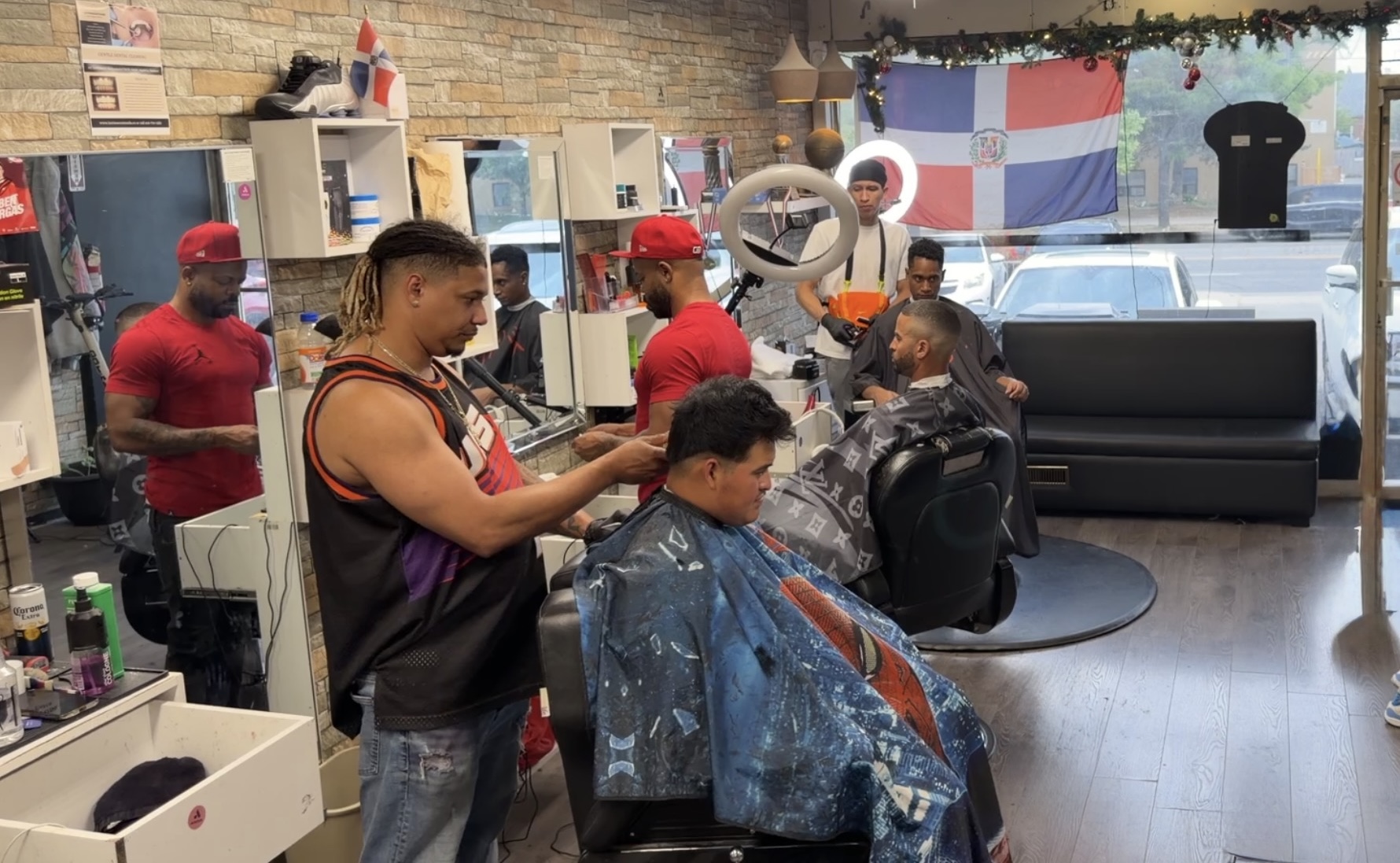 Inside Looney Tunes Barbershop with multiple barbers serving clients