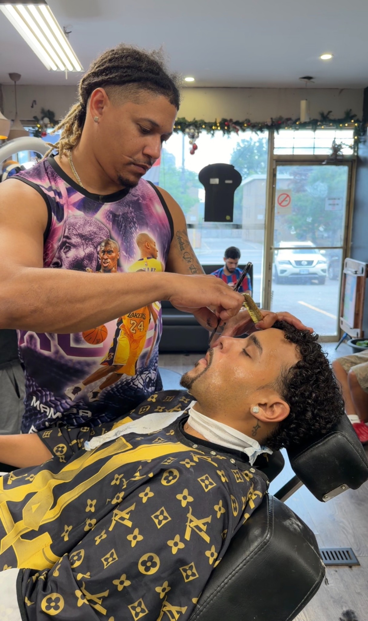 Barber shaping a client's haircut