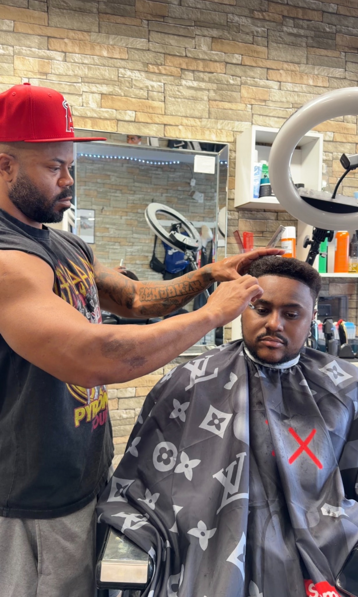 Barber detailing a client's haircut